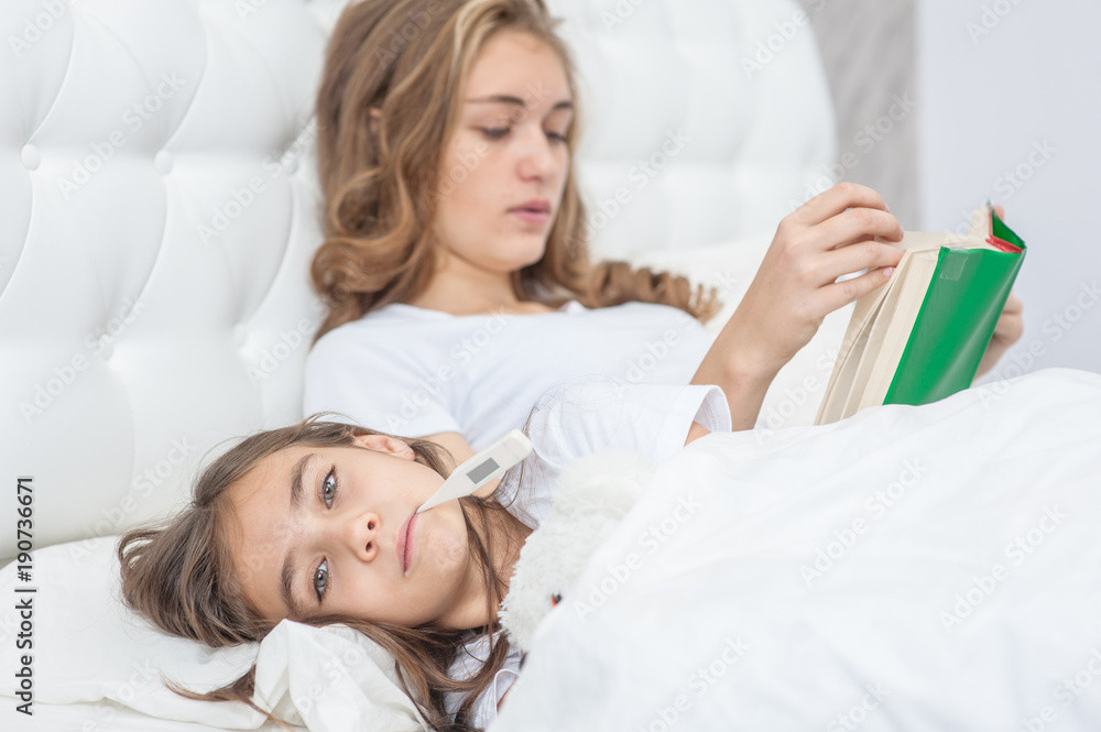 mother reads the book of her sick daughter