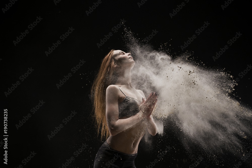 Red-haired girl dancing in white dust cloud view Red-haired girl dancing in white dust cloud view
