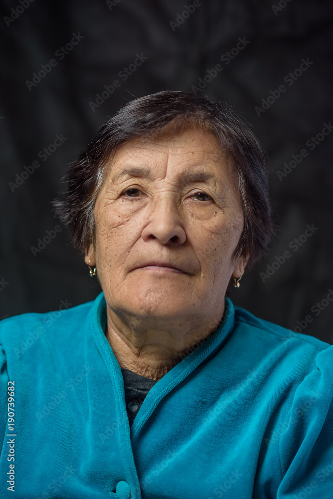 portrait of an elderly thoughtful woman on a dark background portrait of an elderly thoughtful woman on a dark background