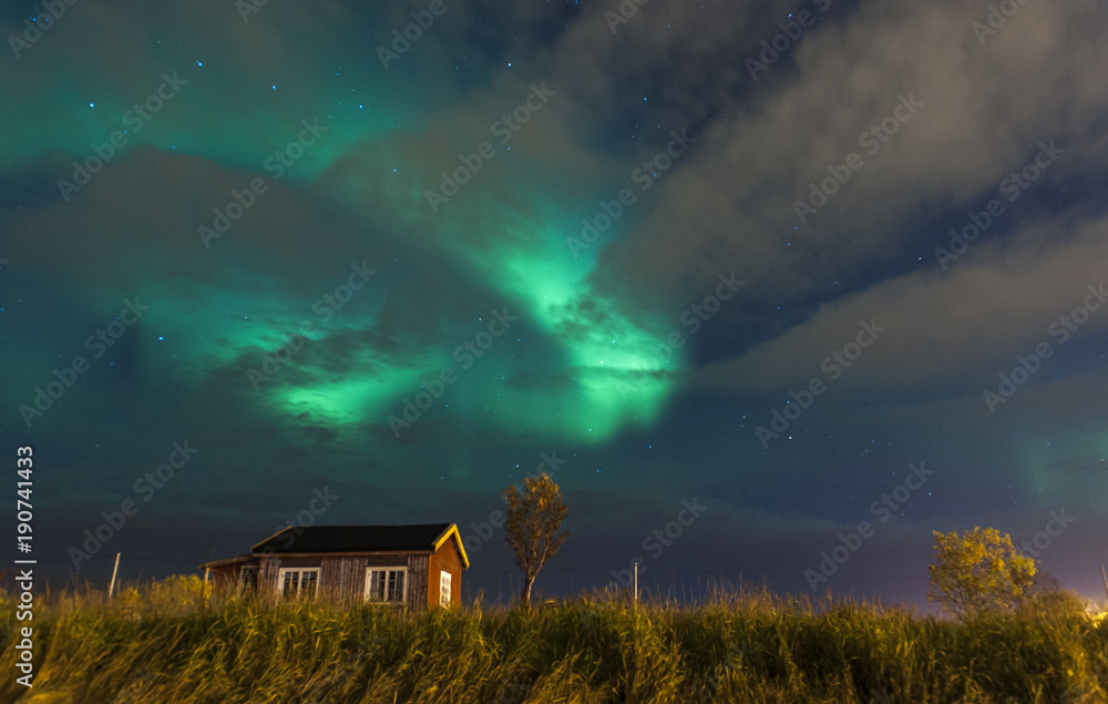 a lonely house on a background of the Northern lights