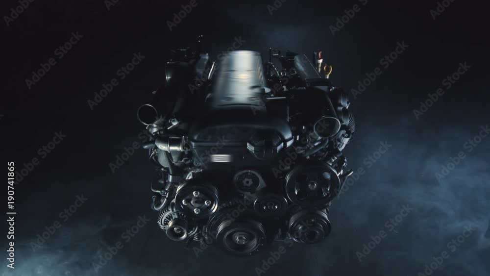 Engine of a cargo logistic car is being repaired in a modern auto workshop. Mechanism is prepared for analysis by checking the pistons and gears. Change the oil and clean the technological solutions