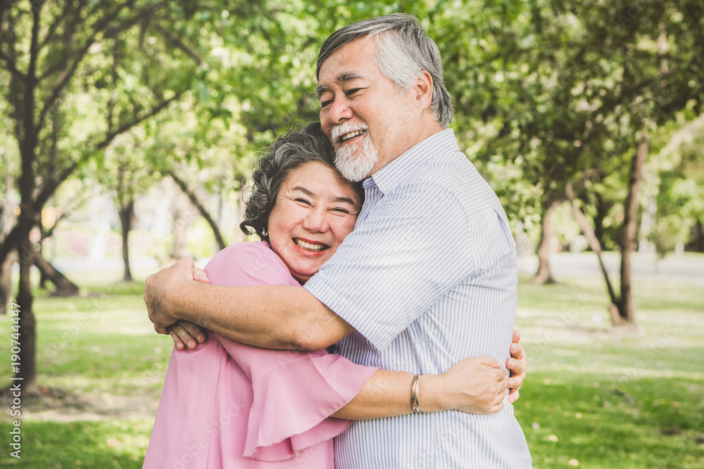 Happy elderly couple with lifestyle after retiree concept. Lovely asian seniors couple embracing together in the park in the morning. Happy elderly couple with lifestyle after retiree concept. Lovely asian seniors couple embracing together in the park in the morning.