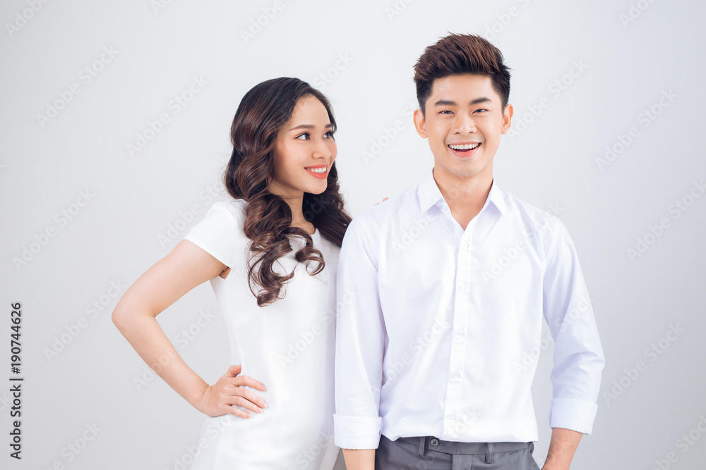 Happy together. Young in love couple smiling and standing against background Happy together. Young in love couple smiling and standing against background