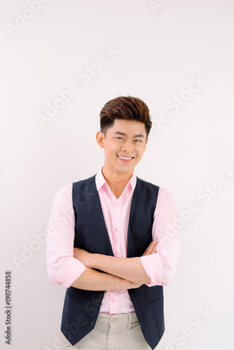 Handsome asian man stand and smile posing on gray background