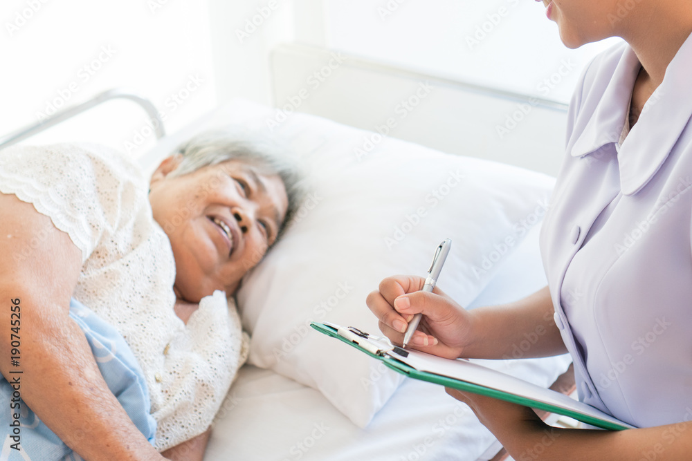 cheerful Asian nurse talking with elderly patient for monitoring and check up. nurse giving consoling to senior and encourage in the hospital. cheerful Asian nurse talking with elderly patient for monitoring and check up. nurse giving consoling to senior and encourage in the hospital.