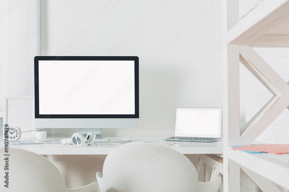 Stylish workspace with empty laptop screen Stylish workspace with empty laptop screen