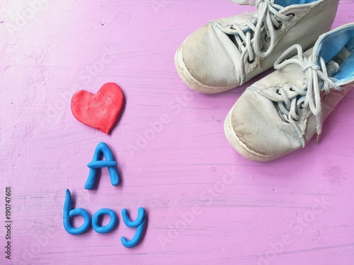 Plasticine clay dough made are cute red heart, ue a boy text and boys sneakers on pink background, lovely wallpaper