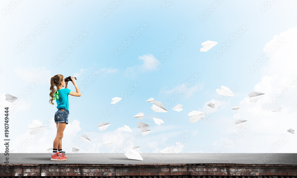 Concept of careless happy childhood with girl of school age looking in future Concept of careless happy childhood with girl of school age looking in future