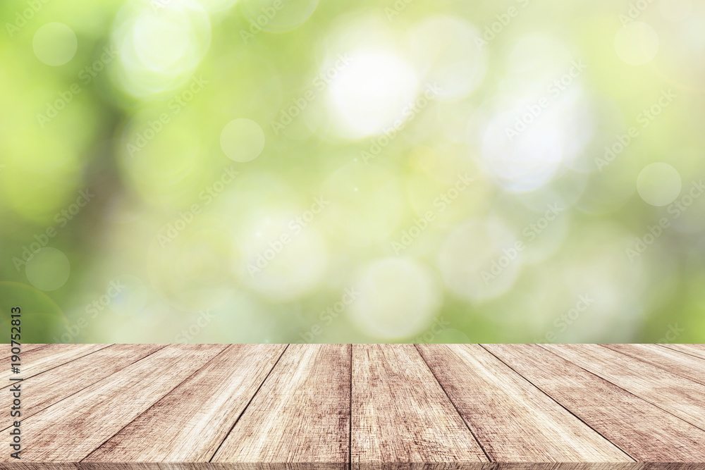 Wood table top on blur nature background with spring or summer Wood table top on blur nature background with spring or summer