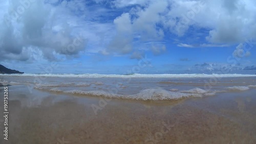 Water splashing waves on beach, bottom view, sea waves crushing on camera, beach sand, stormy ocean