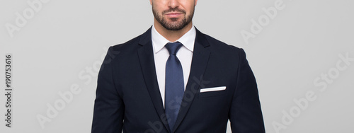 Young businessman banner on grey background
