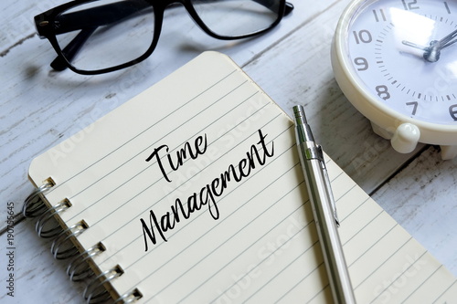 Wallpaper Mural Sunglasses,table clock,pen and notebook written with 'TIME MANAGEMENT' on white wooden background. Torontodigital.ca