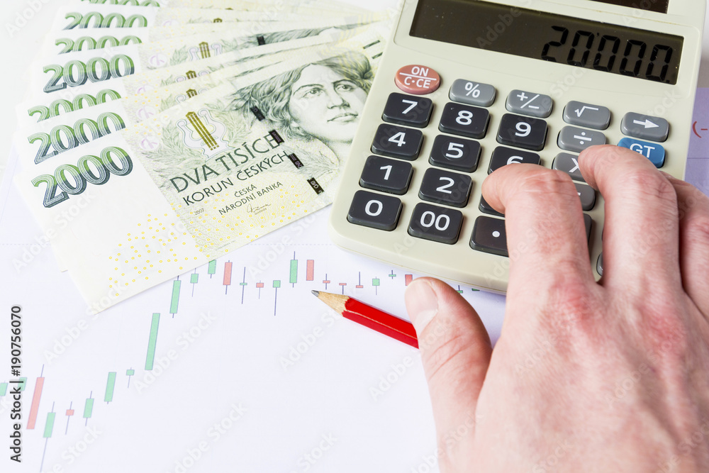 Calculator with green czech money on economic charts Calculator with green czech money on economic charts