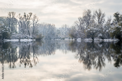 Panorama of the frozen lake and snow-covered trees