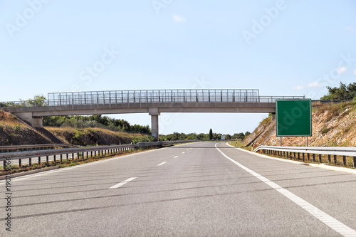 Scenic view on overpass and highway road leading through in Croatia, Europe / Beautiful natural environment, sky and clouds in background / Transport and traffic infrastructure / Signs and signaling.