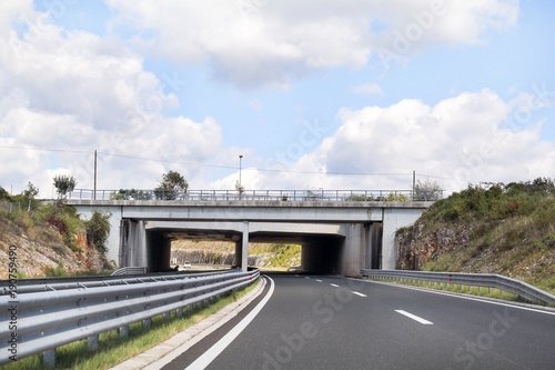 Fotografia Scenic view on overpass and highway road leading through in Croatia, Europe / Beautiful natural environment, sky and clouds in background / Transport and traffic infrastructure / Signs and signaling