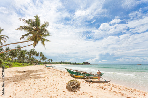 Balapitiya, Sri Lanka - A woman preparing for a canoe tour at the beach of Balapitiya