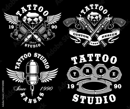 Set of monochrome tattoo emblems on dark background