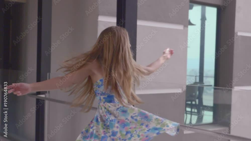 Beautiful blonde girl with healthy long hair outdoors. Happy smiling young woman enjoying vacation, having fun and spinning in the hall. Happiness, freedom concept. Slow motion. Beautiful blonde girl with healthy long hair outdoors. Happy smiling young woman enjoying vacation, having fun and spinning in the hall. Happiness, freedom concept. Slow motion.