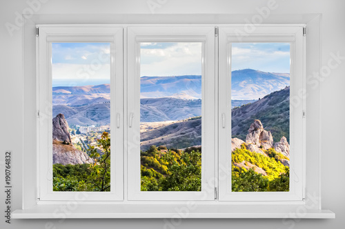 View from the window. Mountain forest landscape under evening sky