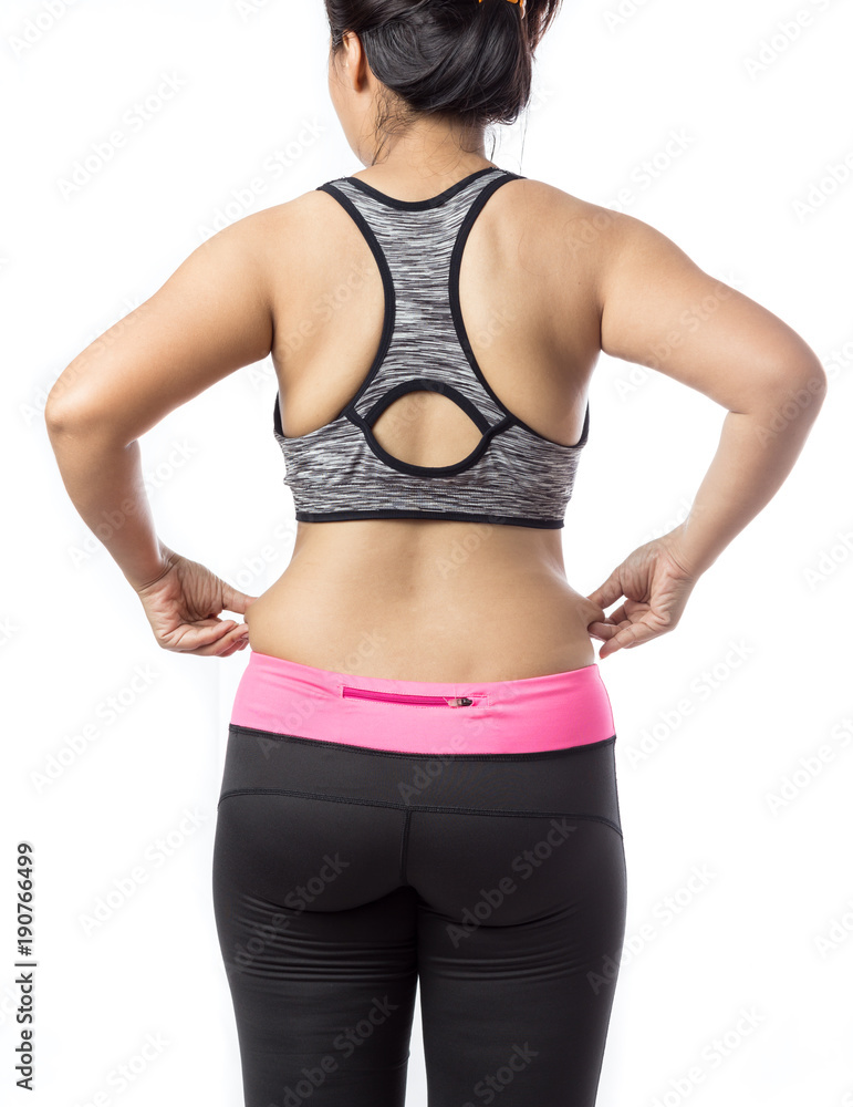 Overweight woman hand pinching excessive belly fat on gray background, Healthy concept Overweight woman hand pinching excessive belly fat on gray background, Healthy concept