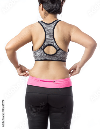 Overweight woman hand pinching excessive belly fat on gray background, Healthy concept