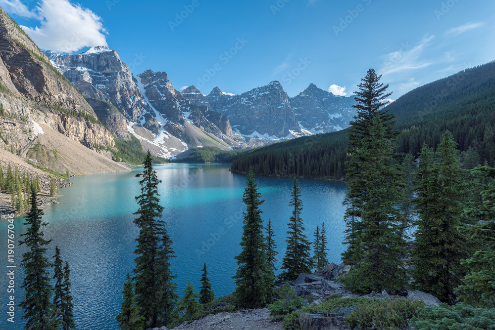 Beautiful turquoise waters of the Moraine Lake at sunset in Rocky Mountains, Banff National Park, Canada.