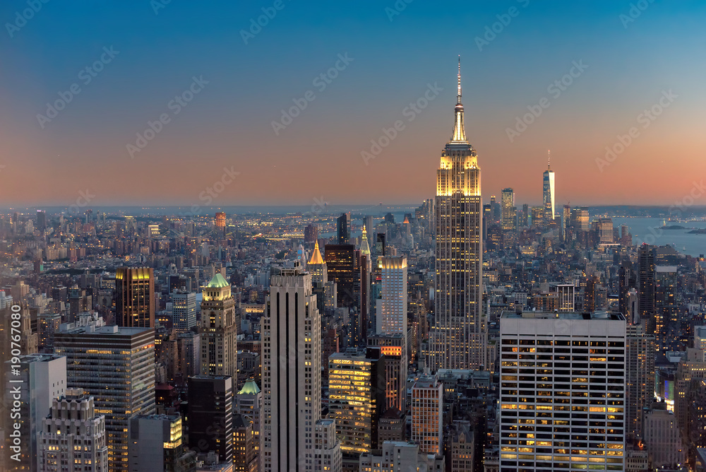 New York City skyline with urban skyscrapers at sunset, NY, USA.