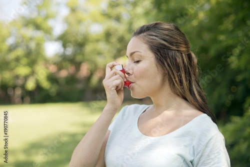 Woman using an inhaler
