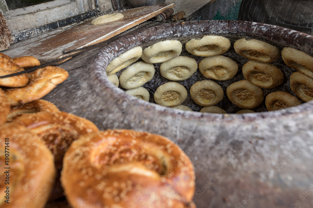 baking naan flat breads in the tradional stove,xinjiang,china