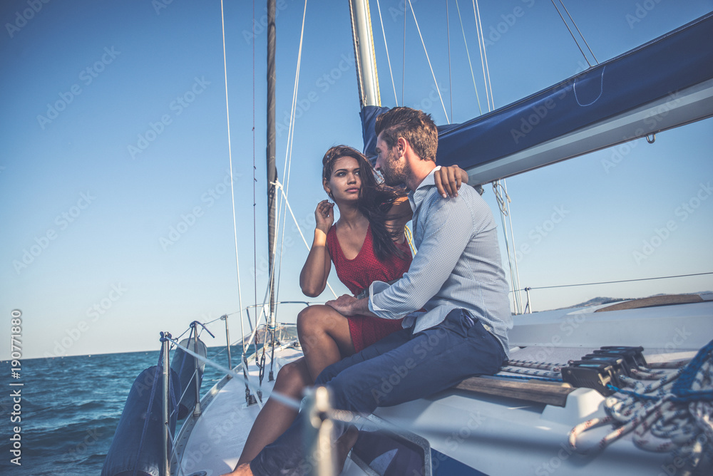 happy couple taking a romantic cruise on the sail boat happy couple taking a romantic cruise on the sail boat