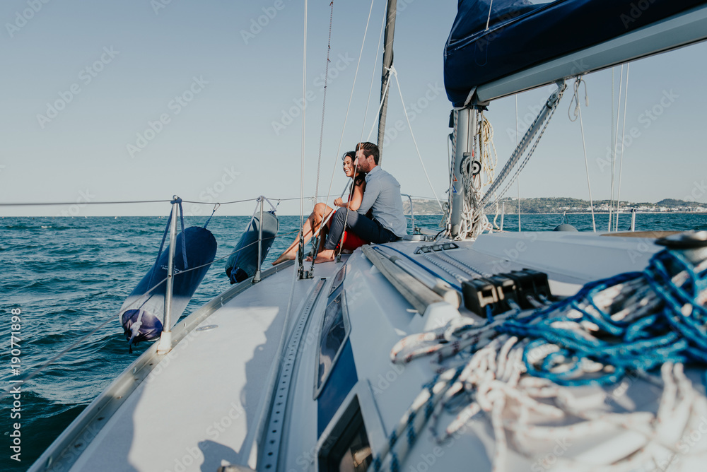 happy couple taking a romantic cruise on the sail boat