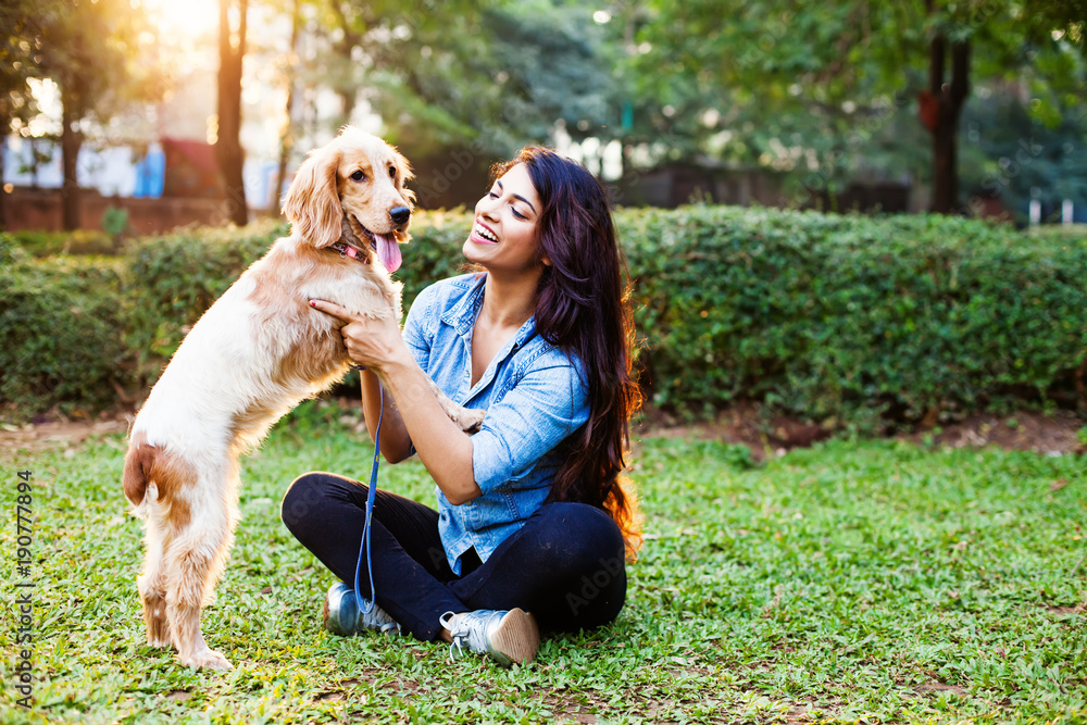 Beautiful indian girl with her cocker spaniel dog