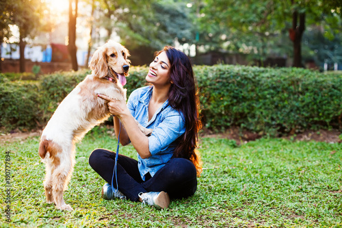 Beautiful indian girl with her cocker spaniel dog