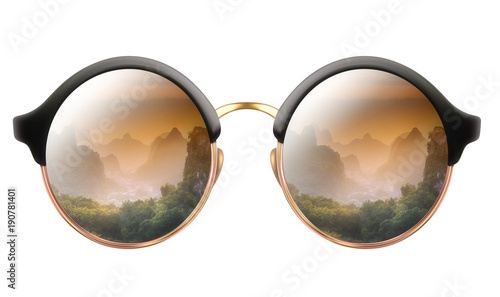 Sunglasses with reflection of cloudy mountains