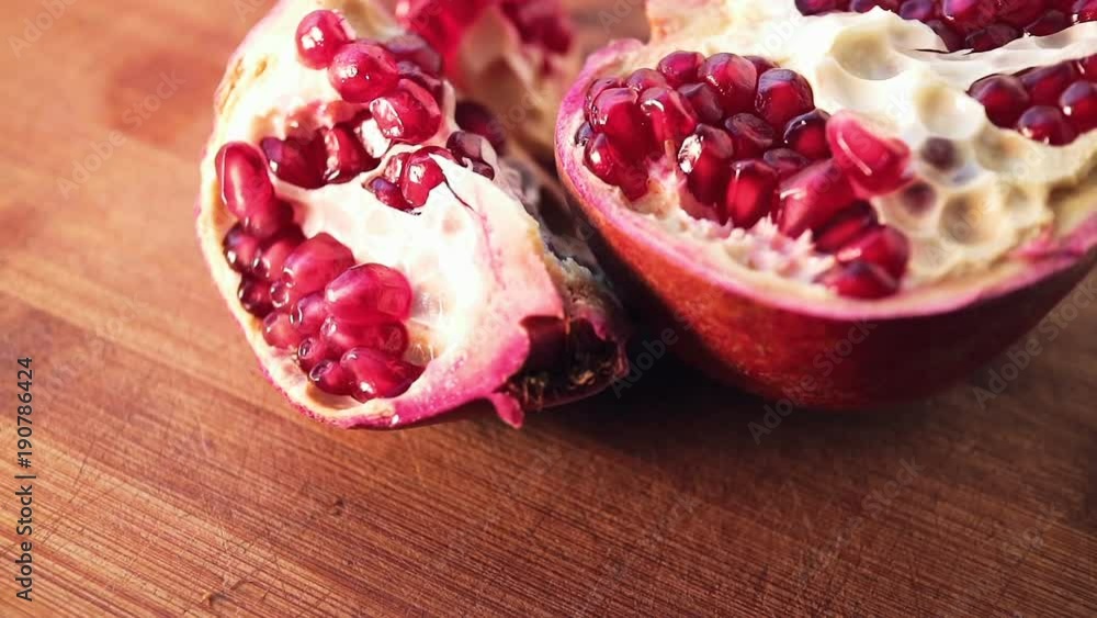 Pomegranate seeds on bamboo board close-up shot. Smooth rotation. Pomegranate seeds on bamboo board close-up shot. Smooth rotation.