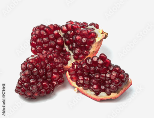 Ripe pomegranate fruit isolated on white background cutout.