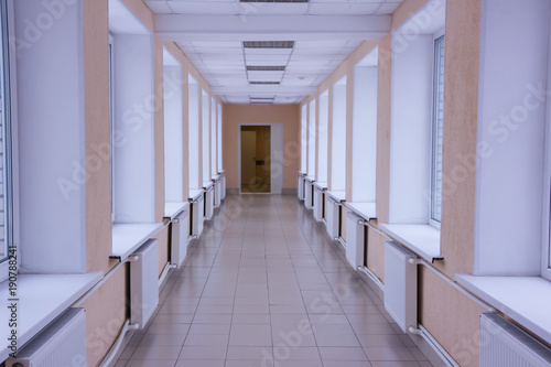 bright hospital corridor. Go to the hospital with windows, from one housing to another. Hospital transition.