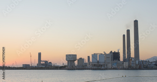 Power station under sunset