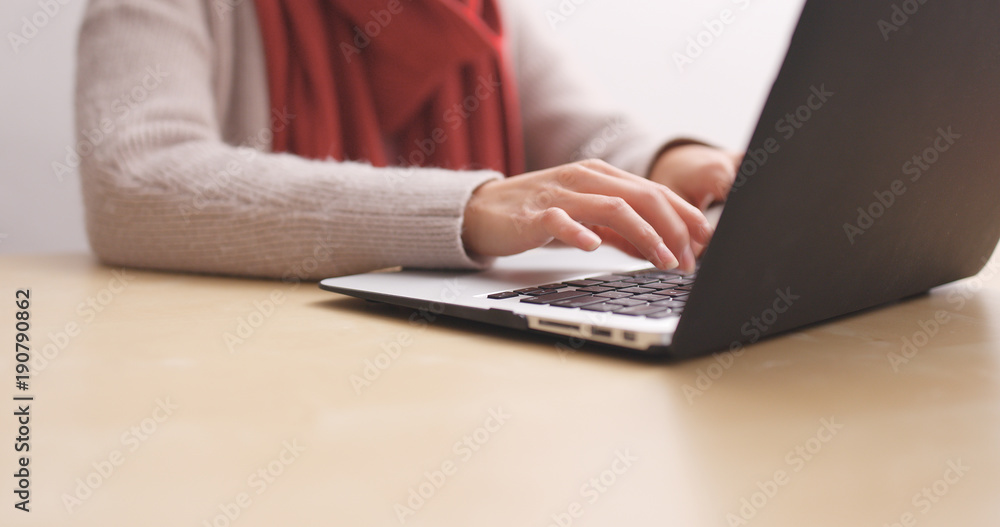 Woman using notebook computer at home Woman using notebook computer at home