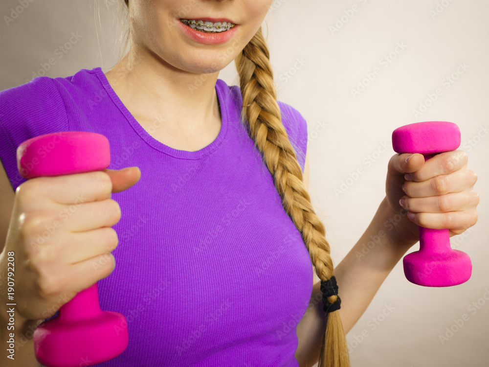 Woman working out at home with dumbbell Woman working out at home with dumbbell