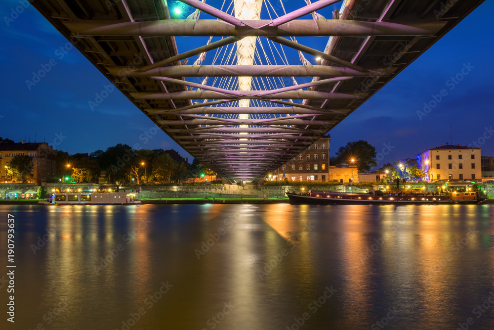 Bernatka footbridge over Vistula river in Krakow at night. Poland. Europe.