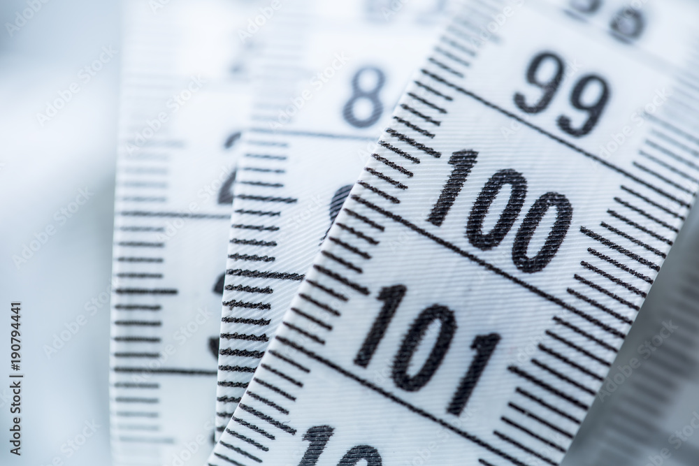 Curved measuring tape. Measuring tape of the tailor. Closeup view of white measuring tape Curved measuring tape. Measuring tape of the tailor. Closeup view of white measuring tape