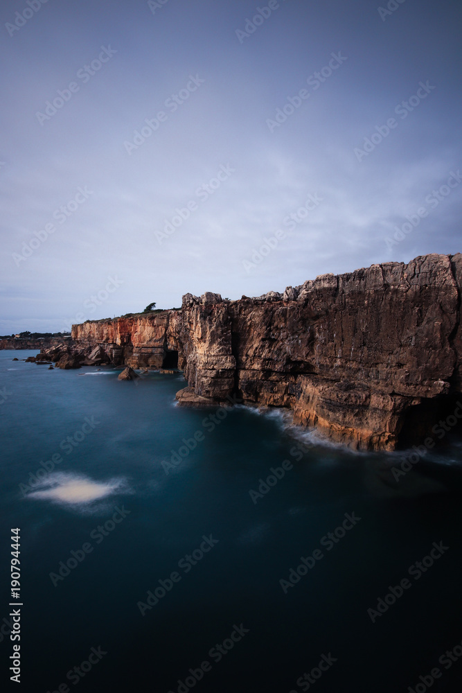 Panoramic view of cliff and sea in the Portuguese coastline. Long exposure