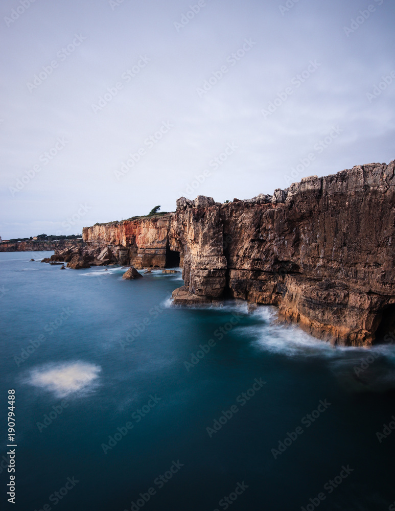 Panoramic view of cliff and sea in the Portuguese coastline. Long exposure