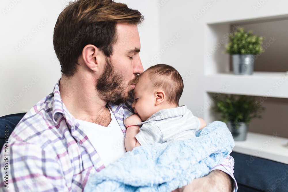 Handsome father holding his cute little baby boy. Handsome father holding his cute little baby boy.