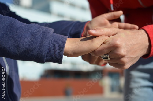 Close up on hand of mother and child on sunny outdoors background. Happy assistance, healthy motion togetherness. Human love, relation, protection support. Holding emotional connection.