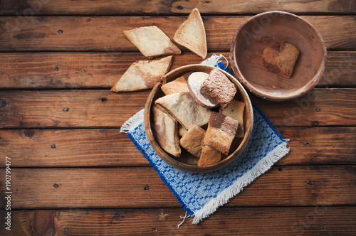 Homemade biscuits in a wooden bowl on rustic background