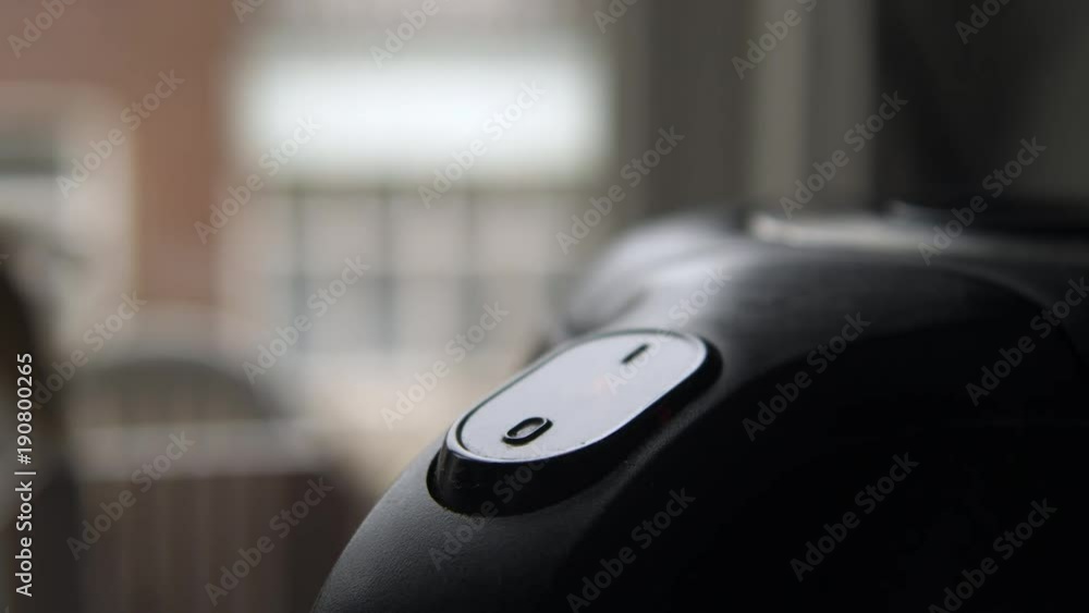 Pushing 'On' button on water boiler. Pushing 'On' button on water boiler.