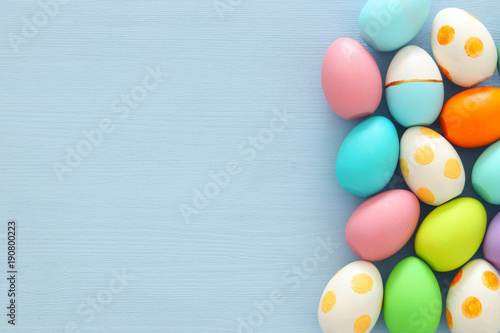 Top view of easter colorful eggs over blue background.